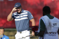 Bryson DeChambeau smiles after his birdie putt on the 18th green during the final round of the Rocket Mortgage Classic golf tournament, Sunday, July 5, 2020, at Detroit Golf Club in Detroit. (AP Photo/Carlos Osorio)