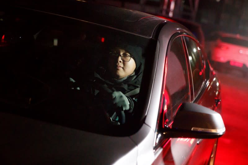 Liu Pengfei, a substitute driver of ride-hailing service platform DiDi Chuxing, drives a client's car in Beijing