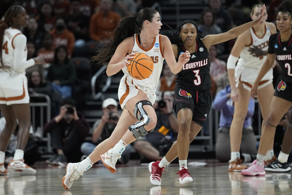 Texas guard Shaylee Gonzales (2) drives around Louisville guard Chrislyn Carr (3) during the first half of a second-round college basketball game in the NCAA Tournament in Austin, Texas, Monday, March 20, 2023. (AP Photo/Eric Gay)