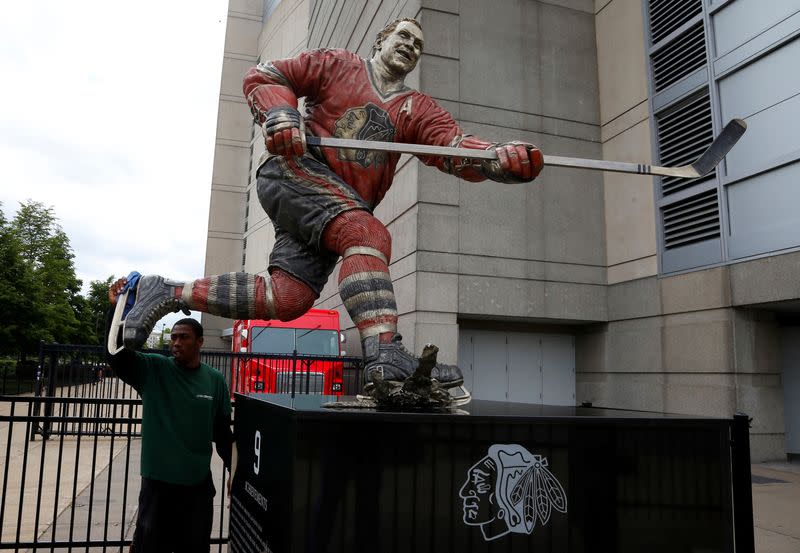 FILE PHOTO: Dontae Anderson cleans the Bobby Hull statue outside the United Center the site of Game 1 of their NHL Western Conference final hockey playoff series in Chicago