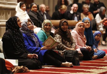 Women talk as the Washington National Cathedral and five Muslim groups hold the first celebration of Muslim Friday Prayers, Jumaa, in the Cathedral's North Transept in Washington, November 14, 2014. REUTERS/Larry Downing