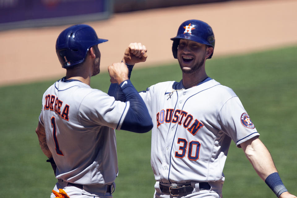 Houston Astros' Kyle Tucker (30) celebrates his two-run home run with teammate Carlos Correa (1) in the fourth inning of a baseball game against the Minnesota Twins, Sunday, June 13, 2021, in Minneapolis. (AP Photo/Andy Clayton-King)