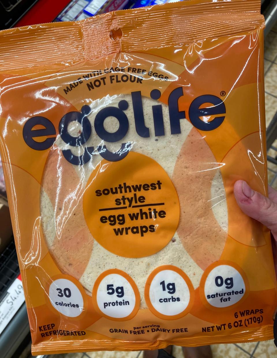 hand holding orange pack of egglife wraps at Aldi