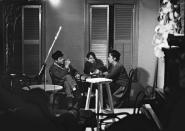 FILE - In this 1962 file photo provided by the Joe Alper Photo Collection LLC, Bob Dylan, left, his girlfriend Suze Rotollo center and Lena Spencer gather around a table at her coffeehouse, Caffe Lena in Saratoga Springs, N.Y. Dylan would surely still recognize the low-ceilinged room in Caffe Lena where he played a couple of gigs 60 years ago. But just about everything else about a venue that bills itself as the nation's oldest continuously operating coffeehouse has undergone some major upgrades as part of a $2 million renovation project bankrolled by some of folk music's biggest names. (Joe Alper Photo Collection LLC/Joe Alper via AP, File)