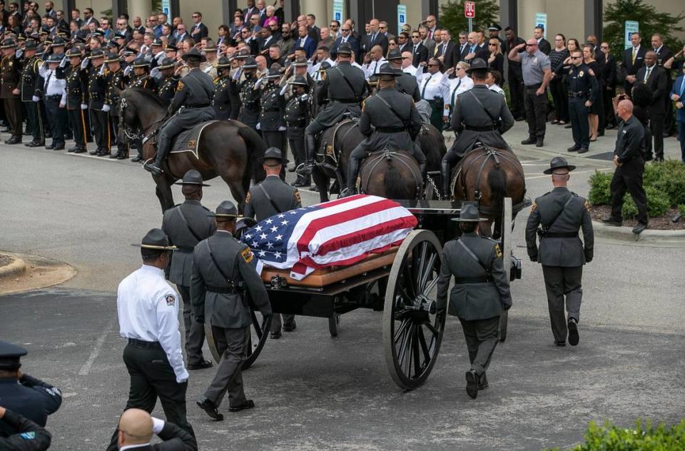 The North Carolina State Highway Patrols Caisson Unit carrying Wake County Deputy Ned Byrds casket arrives at Providence Baptist Church for his funeral on Friday, August 19, 2022 in Raleigh, N.C.