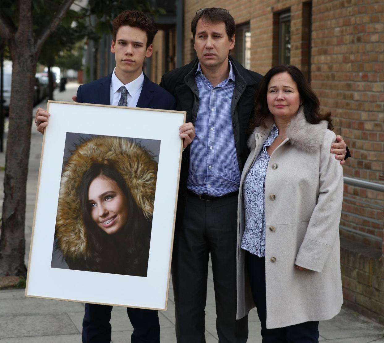 Nadim and Tanya Ednan-Laperouse hold a picture, alongside their son Alex, of their daughter Natasha, who died from an allergic reaction to a Pret sandwich