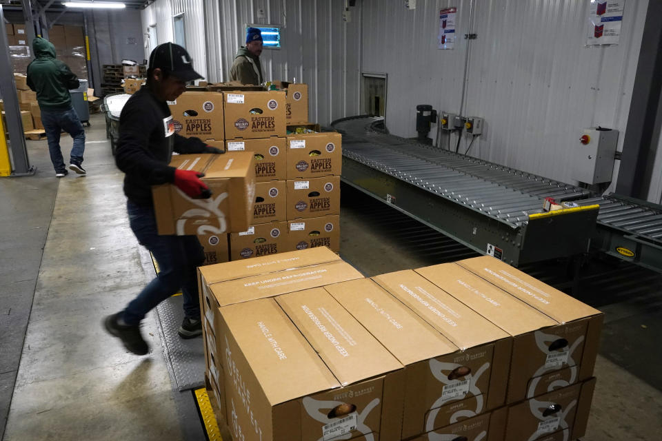 Boxes of apple packages are stacked for delivery to grocery stores at the BelleHarvest packing and storage facility, Tuesday, Oct. 4, 2022, in Belding, Mich. This process happens repeatedly throughout the year as apples are taken out of special storage rooms that help them stay fresher. Increasingly, customers are demanding crisp apples year-round, and growers and packers are finding more ways to try to meet that demand. (AP Photo/Carlos Osorio)