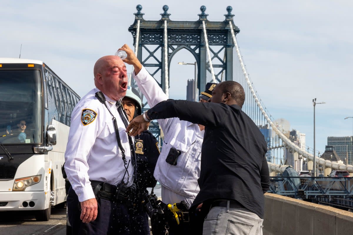 James McCarthy, NYPD assistant chief, is assisted after seemingly being affected by a chemical irritant as police arrest pro-Palestinian demonstrators blocking traffic on the Manhattan Bridge (Getty Images)