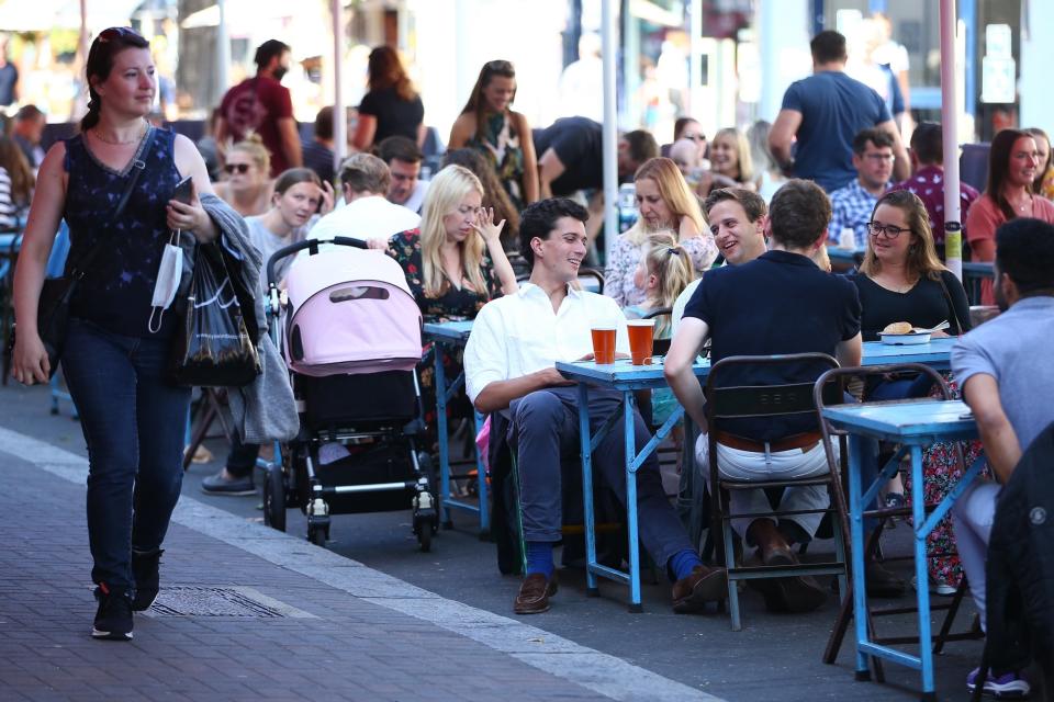 Revellers eat out in south London on the day before new restrictions were imposed (Getty Images)