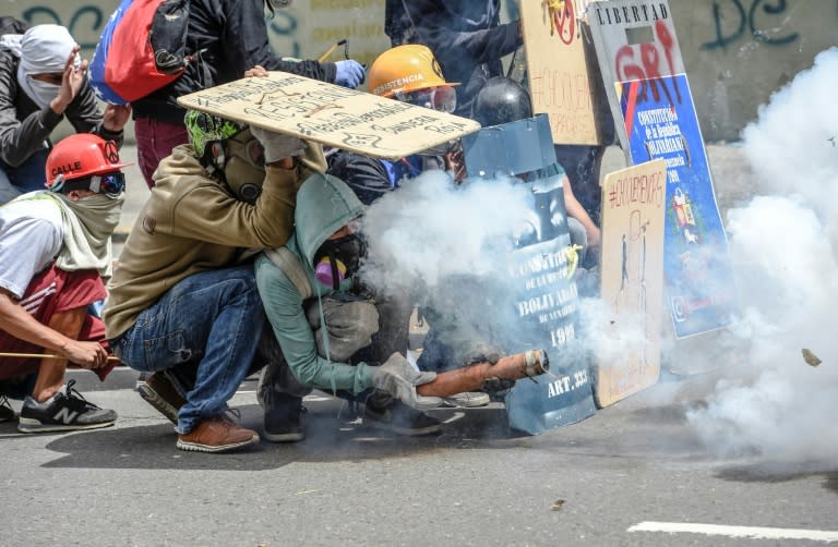 Opposition demonstrators clash with police during a protest in Caracas