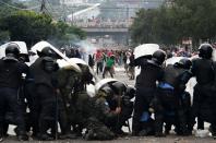 <p>Supporters of Honduran presidential candidate for the Opposition Alliance against the Dictatorship coalition, Salvador Nasralla, clash with soldiers and riot police near the Electoral Supreme Court (TSE), as the country waits for the final results of the week-end’s presidential election, in Tegucigalpa, on Nov. 30, 2017. (Photo: Orlando Sierra/AFP/Getty Images) </p>