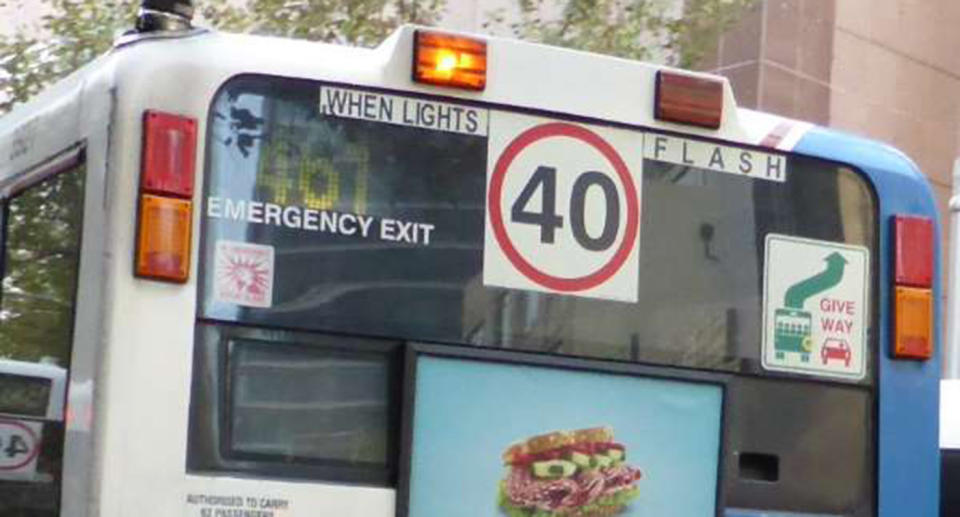 A NSW bus with 40 speed limit sign and flashing lights signals drivers to slow to 40km/h.