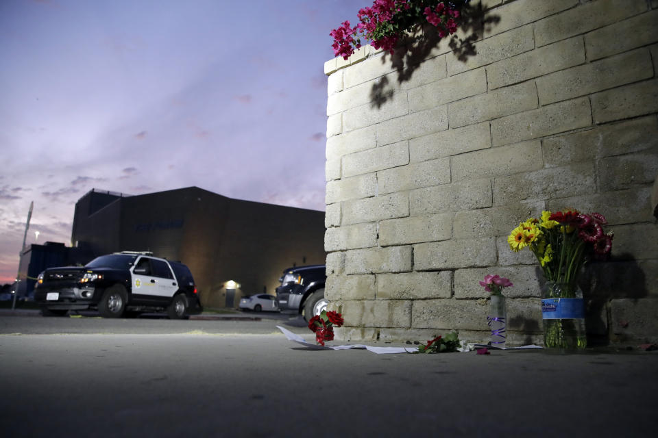 Flowers are placed in front of Saugus High School in the aftermath of a shooting on Thursday, Nov. 14, 2019, in Santa Clarita, Calif. (AP Photo/Marcio Jose Sanchez)