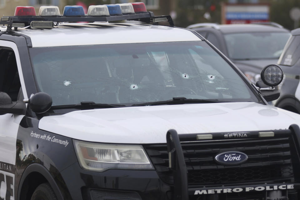 A police vehicle with bullet holes is seen at the scene in the area of Blue Diamond Road and Durango Drive in Las Vegas, Wednesday, Dec. 27, 2023, after officers from two Nevada law enforcement agencies opened fire during a pre-dawn chase through Las Vegas as they tried to stop a man who fatally shot his mother, then stole a police cruiser and carjacked bystanders at gunpoint while trying to evade police, authorities said. (Rachel Aston/Las Vegas Review-Journal via AP)