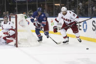 New York Rangers center Andrew Copp (18) and Carolina Hurricanes defenseman Ian Cole (28) chase the puck during the second period of an NHL hockey game Tuesday, April 12, 2022, in New York. (AP Photo/Bebeto Matthews)