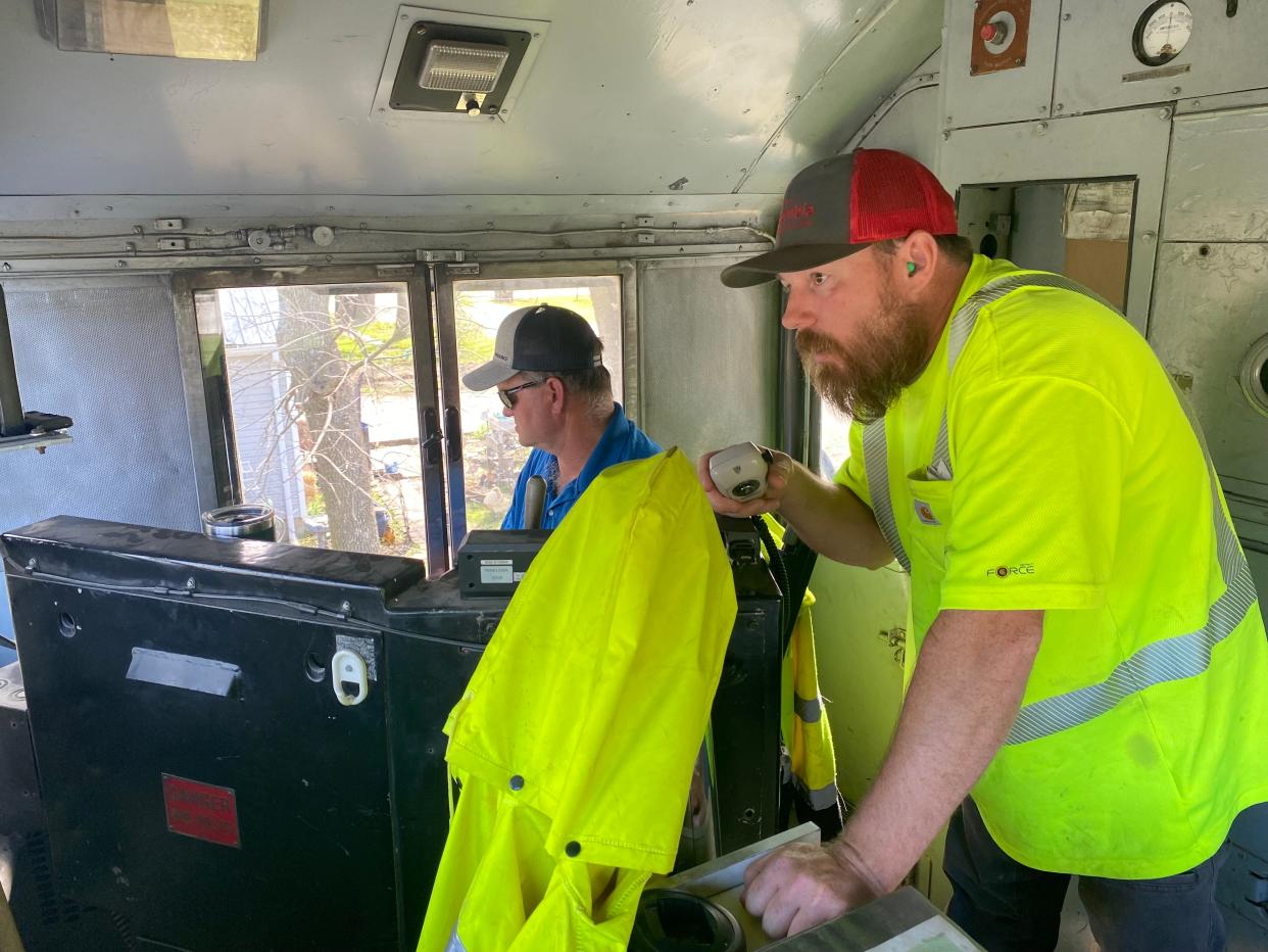 Shane Riley, railroad operation, drives the locomotive of the Columbia Terminal Railroad as railroad worker James Day radios to the dispatcher of Norfolk Southern Railroad to request to be on its tracks in Centralia on April 9. The dispatcher is in Atlanta.