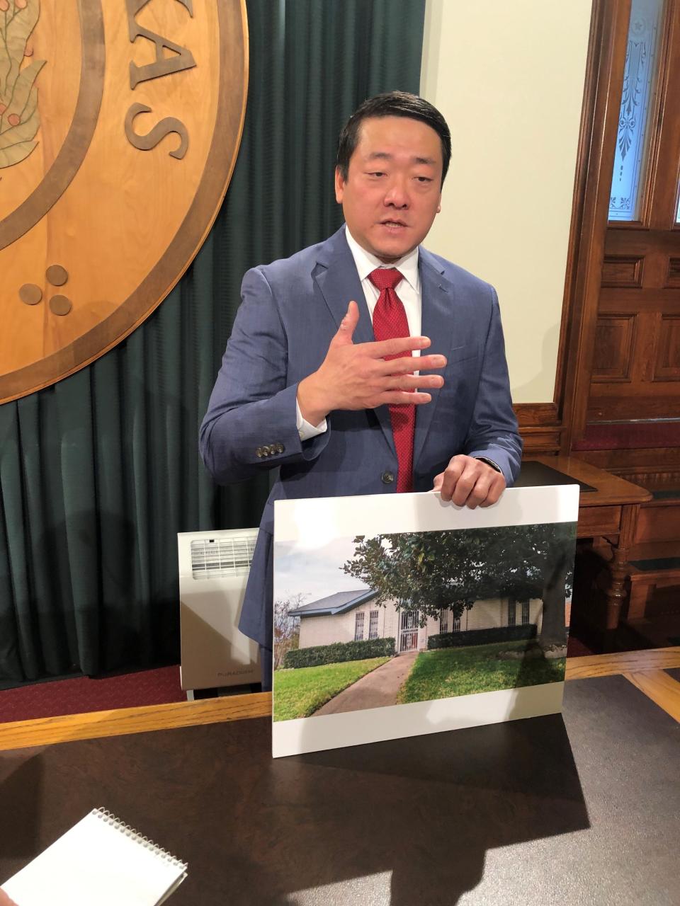 State Rep. Gene Wu with a photo of the house in Houston his parents purchased while going through the process of becoming U.S. citizens.