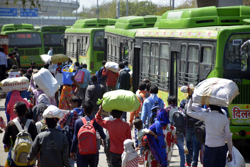 GHAZIABAD, INDIA - MARCH 29: A wave of migrant workers seen at Anand Vihar Bus Terminus as they head to their native state on Day 5 of the 21 day nationwide lockdown imposed by PM Narendra Modi to curb the spread of coronavirus, on March 29, 2020 in Ghaziabad, India. (Photo by Sakib Ali/Hindustan Times via Getty Images)