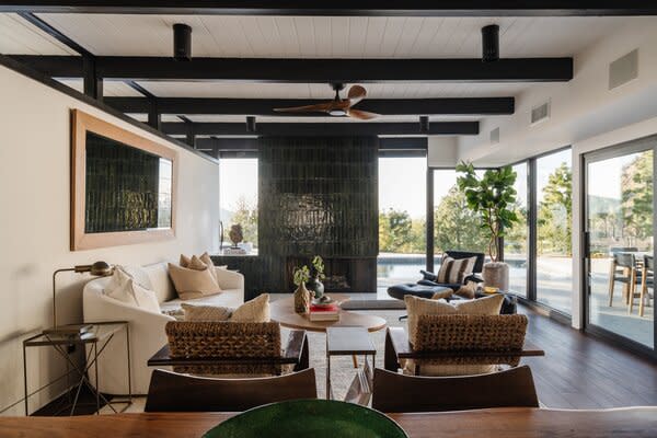 Floor-to-ceiling glazing wraps around the main living room, framing striking canyon views.