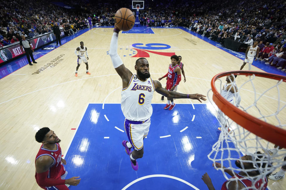 Los Angeles Lakers' LeBron James goes up for a dunk during the first half of an NBA basketball game against the Philadelphia 76ers, Friday, Dec. 9, 2022, in Philadelphia. (AP Photo/Matt Slocum)