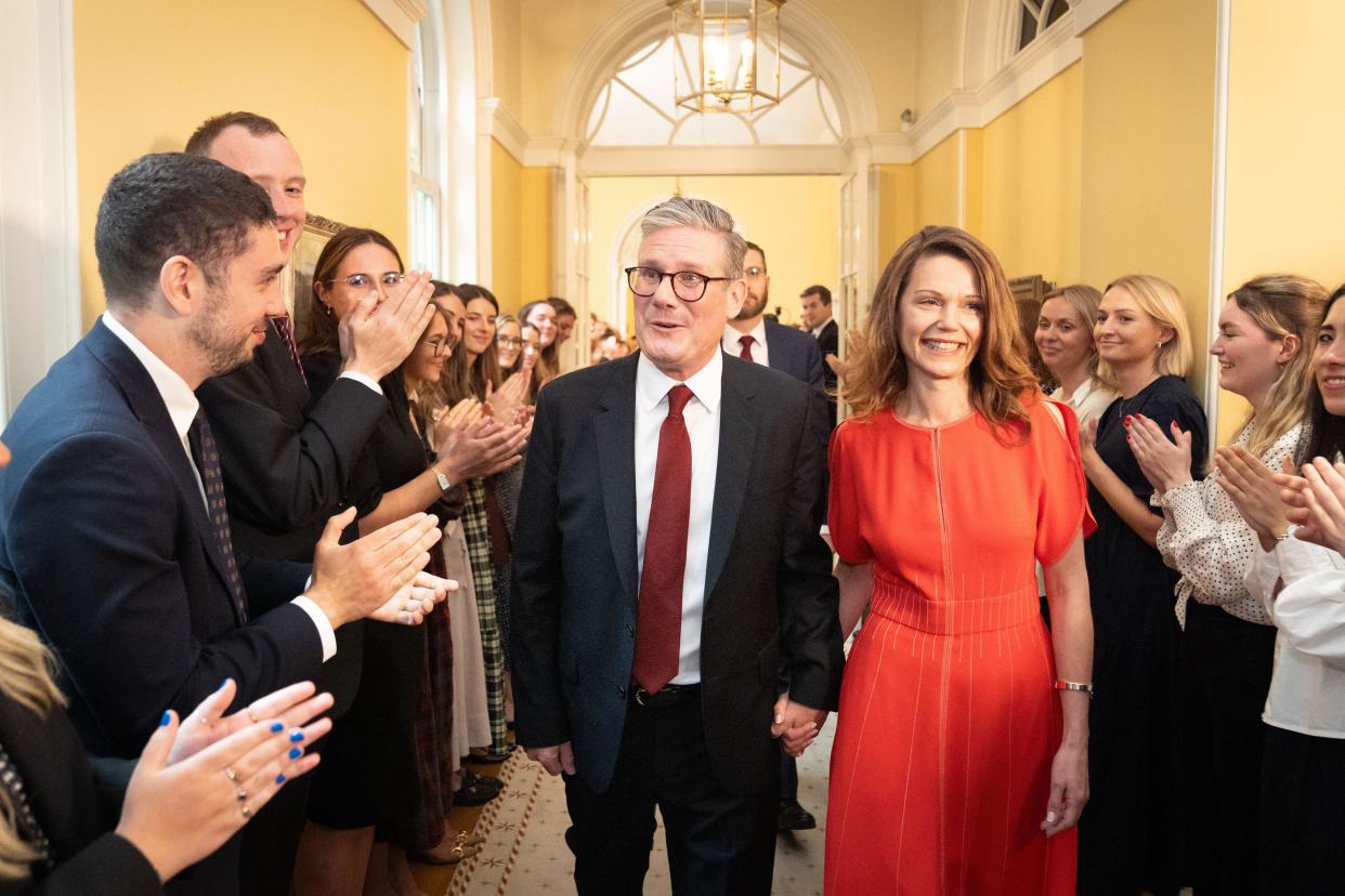 Newly elected Prime Minister Sir Keir Starmer with his wife Victoria Starmer are clapped in by staff as they enter his official London residence at No 10 Downing Street for the first time after the Labour Party won a landslide victory at the 2024 General Election. Picture date: Friday July 5, 2024.