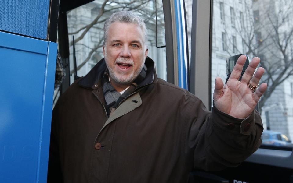 Liberal leader Couillard boards his campaign bus after Quebec's Premier Marois called an election in Quebec City