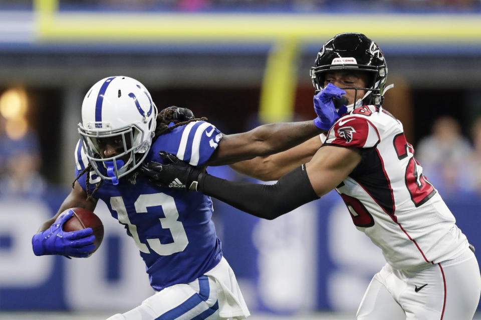 Indianapolis Colts wide receiver T.Y. Hilton (13) is tackled by Atlanta Falcons cornerback Isaiah Oliver (26) during the first half of an NFL football game, Sunday, Sept. 22, 2019, in Indianapolis. (AP Photo/Michael Conroy)