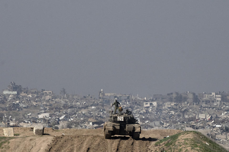 Israeli soldiers overlook the Gaza Strip from a tank, as seen from southern Israel, Friday, Jan. 19, 2024. (AP Photo/Maya Alleruzzo)