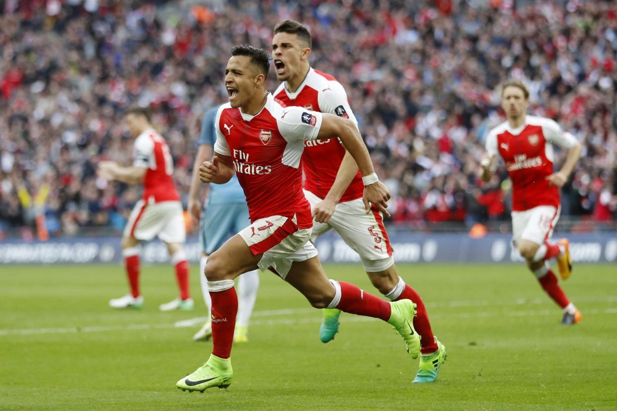 Sanchez on song: The forward celebrates his FA Cup semi-final winner against Man City: REUTERS