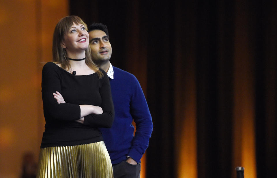 Emily Gordon, left, and her husband Kumail Nanjiani, co-writers of the upcoming film "The Big Sick," watch footage from the film onstage during the Amazon Studios presentation at CinemaCon 2017 at Caesars Palace on Thursday, March 30, 2017, in Las Vegas. Nanjiani also stars in the film. (Photo by Chris Pizzello/Invision/AP)