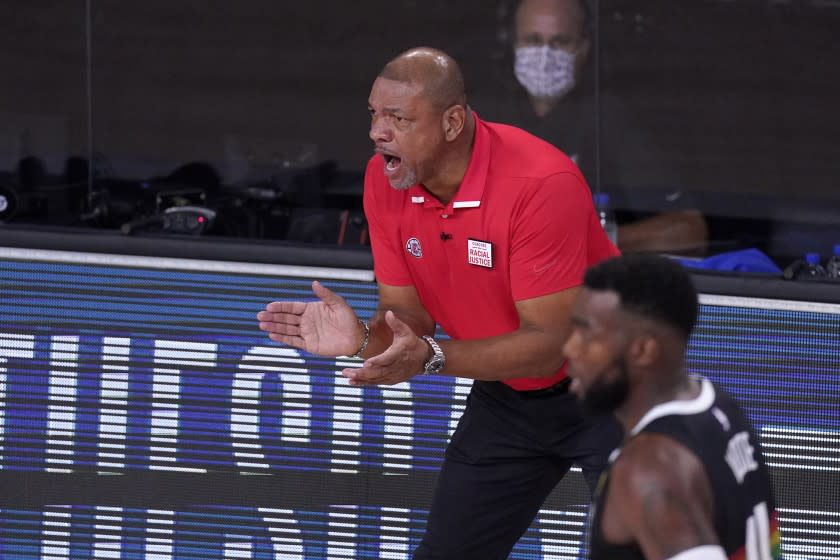 Los Angeles Clippers' Doc Rivers encourages his players during the first half of an NBA conference.