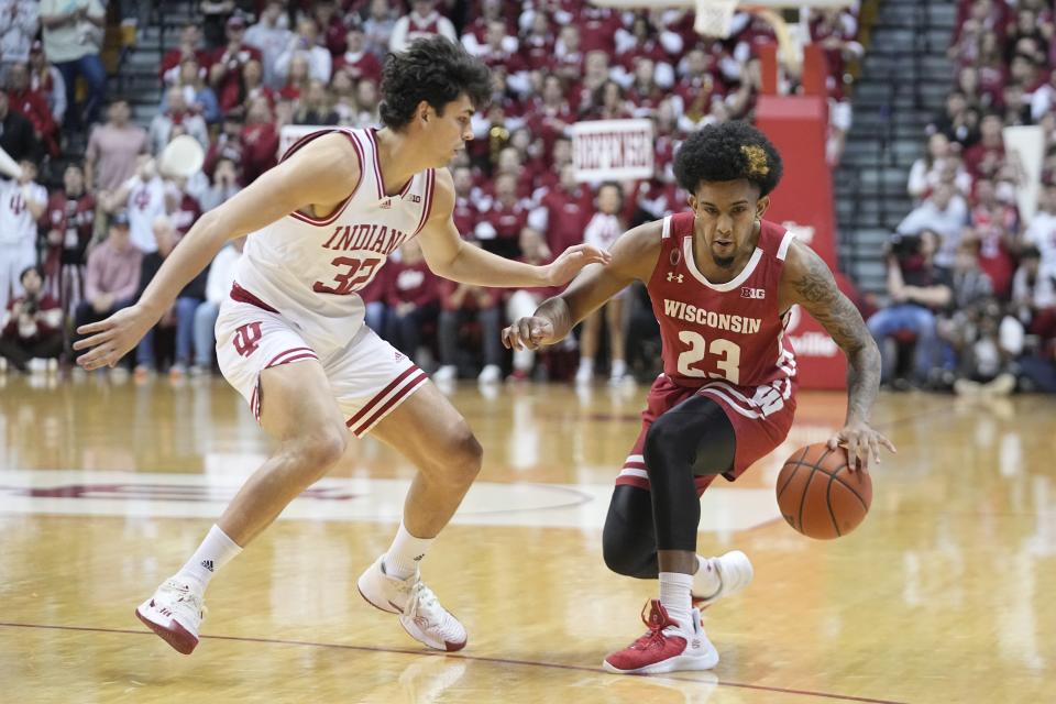 Wisconsin's Chucky Hepburn (23) is defended by Indiana's Trey Galloway (32) during the first half of an NCAA college basketball game, Saturday, Jan. 14, 2023, in Bloomington, Ind. (AP Photo/Darron Cummings)