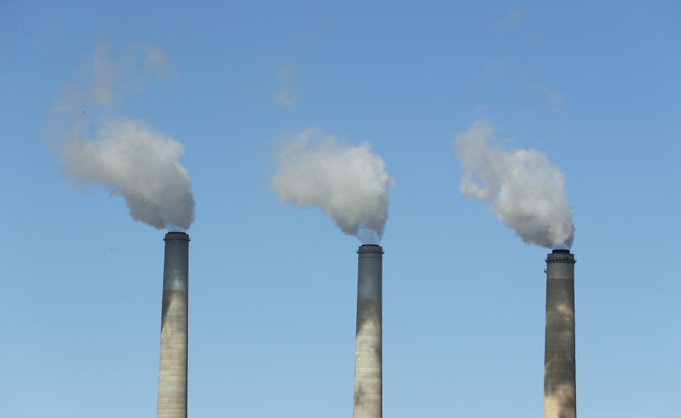 Emissions rise out of three large smokestacks of a coal-fired plant in Utah. A new study suggests the systemic changes scientists say are necessary to avoid the worst effects of warming temperatures will&nbsp;not be done by corporations alone. (Photo: George Frey/Getty Images)