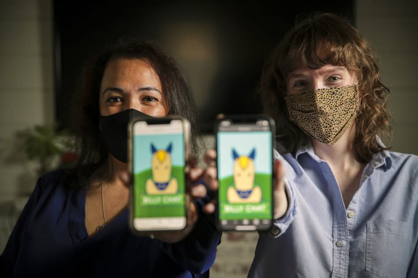 San Dimas, CA - March 05: Cecilia Santiago-Gonzalez, Assistant VP, Strategic Initiatives for Student Success, left, and Communication Specialist Zoe Lance managers of Billy Chat, an artificial intelligence text messaging robot for students communication at Cal Poly Pomona. residence on Friday, March 5, 2021 in San Dimas, CA.(Irfan Khan / Los Angeles Times)