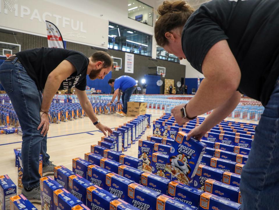 Move For Hunger attempts to break the Guinness world records for the most cereal boxes toppled in domino fashion at the Henry Ford Detroit Pistons performance center in Detroit on Thursday, Oct. 12, 2023.