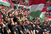 Hungarian fans wave their national flags prior to the Euro 2020 soccer championship group F match between Hungary and France, at the Ferenc Puskas stadium in Budapest, Saturday, June 19, 2021. (AP Photo/Darko Bandic, Pool)