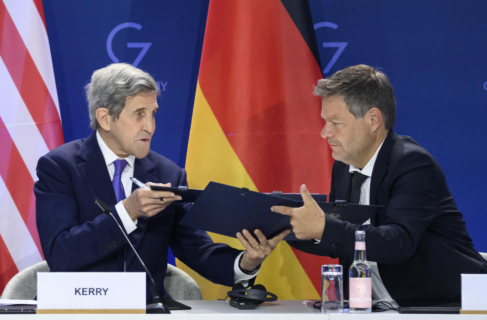 German Economy and Climate Minister Robert Habeck, right, and John Kerry, left, Special Envoy of the U.S. President for Climate, sign a declaration of intent to establish a German-American climate and energy partnership between the United States of America and Germany at the meeting of the G7 Ministers for Climate, Energy and Environment in Berlin, Germany, Monday, May. 27, 2022. (Bernd von Jutrczenka/dpa/dpa via AP)