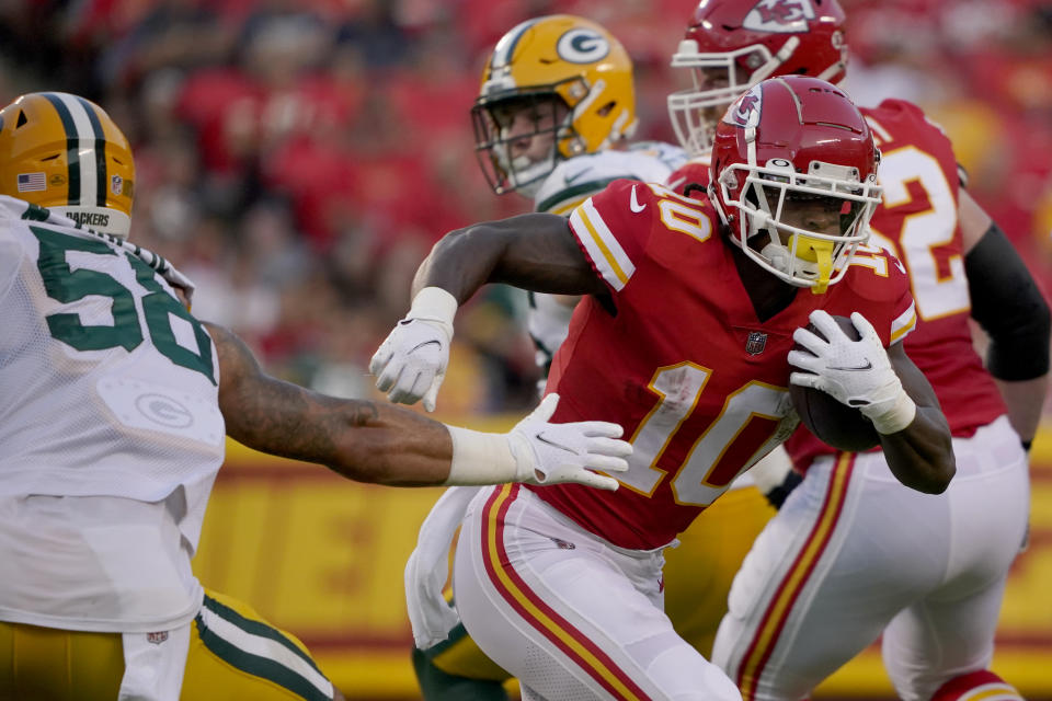 Kansas City Chiefs running back Isiah Pacheco (10) runs with the ball past Green Bay Packers linebacker Isaiah McDuffie (58) during the first half of an NFL preseason football game Thursday, Aug. 25, 2022, in Kansas City, Mo. (AP Photo/Ed Zurga)