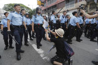 A supporter begs police officer not to attack protesters in Hong Kong Saturday, July 13, 2019. Several thousand people marched in Hong Kong on Saturday against traders from mainland China in what is fast becoming a summer of unrest in the semi-autonomous Chinese territory. (AP Photo/Kin Cheung)