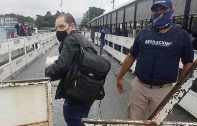 In this photo provided by the Kenemore family, Jerrel Kenemore stands at a Colombian checkpoint in the middle of the Simon Bolivar international bridge connecting San Antonio del Tachira, Venezuela with Villa del Rosario, Colombia, the second week of March 2022. Kenemore, from the Dallas area, is one of at least three American citizens who were quietly arrested in 2022 allegedly trying to enter Venezuela illegally and are being held at a maximum security prison facing long sentences, The Associated Press has learned. (Kenemore family via AP)