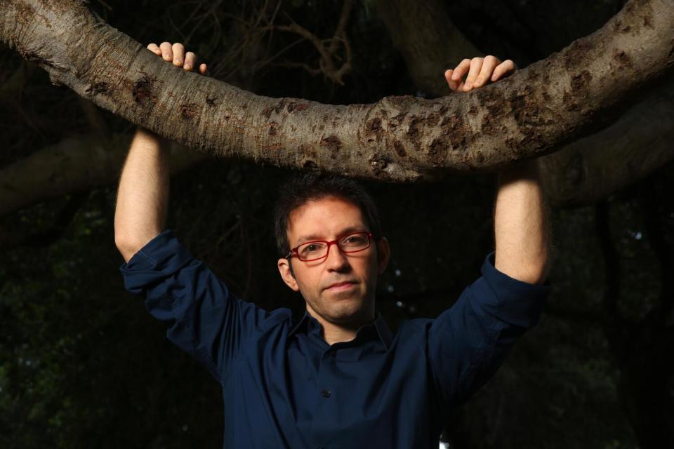 Helder Guimaraes rests his hands on a branch in 2020.