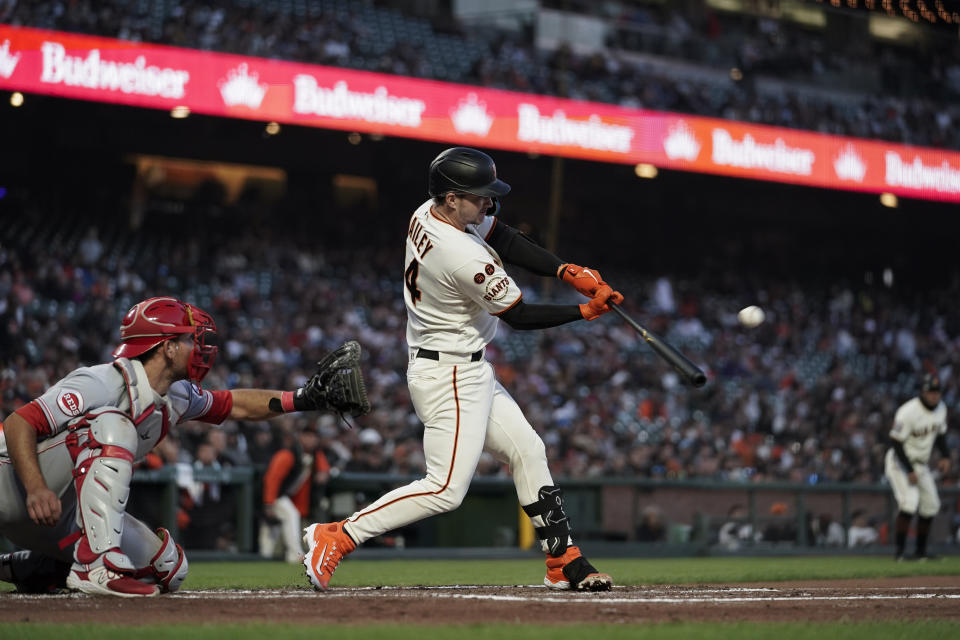San Francisco Giants' Patrick Bailey, front right, hits an RBI double against the Cincinnati Reds during the third inning of a baseball game Monday, Aug. 28, 2023, in San Francisco. (AP Photo/Godofredo A. Vásquez)