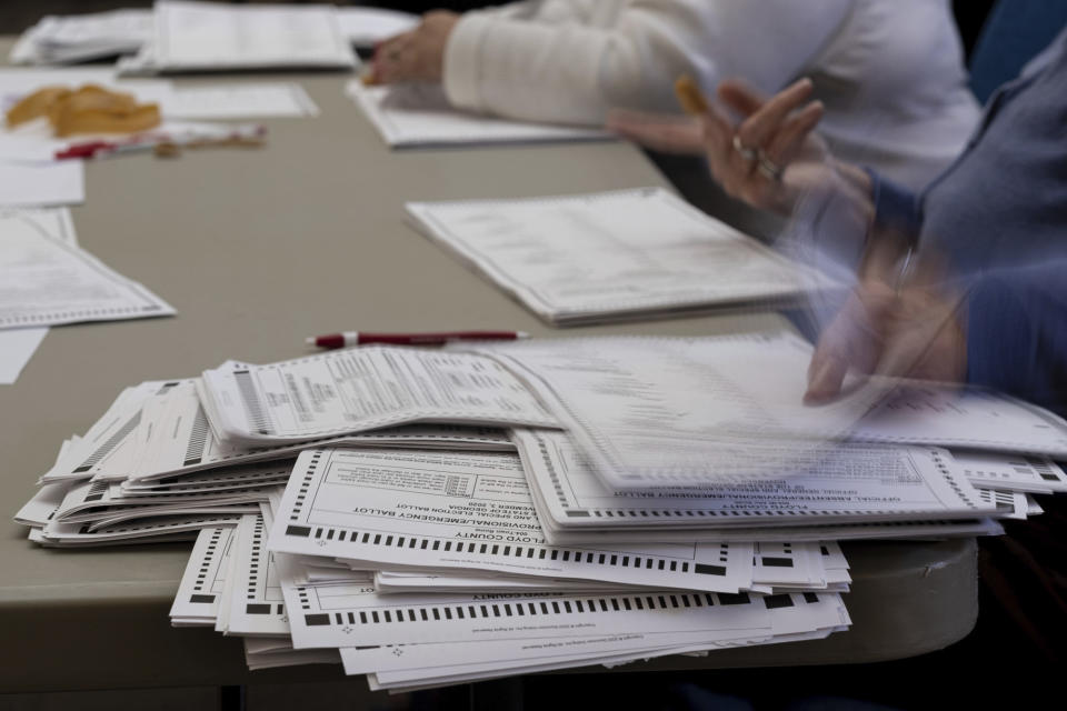 FILE - In this Nov. 13, 2020, file photo officials sort ballots during an audit at the Floyd County administration building in Rome, Ga. (AP Photo/Ben Gray, File)