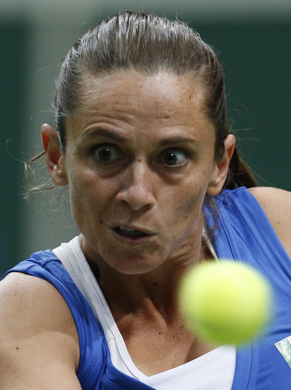 Italy's Roberta Vinci returns a ball to Czech Republic's Petra Kvitova during their Fed Cup semifinal tennis match in Ostrava, Czech Republic, Sunday, April 20, 2014. (AP Photo/Petr David Josek)