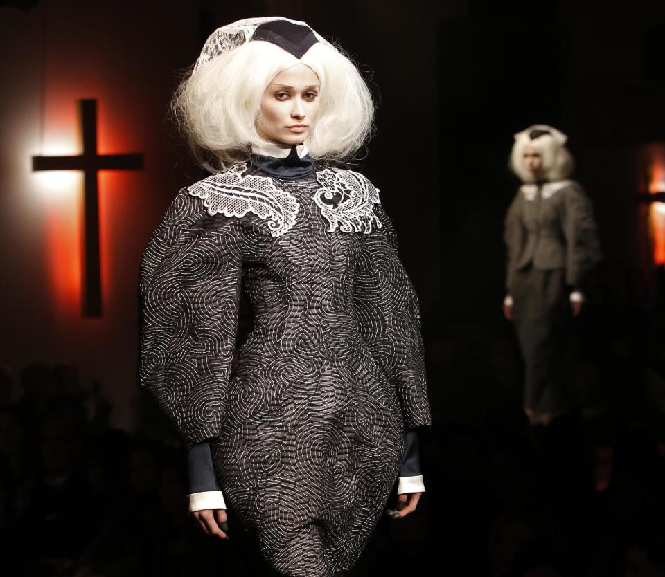 A model walks the runway during the presentation of the Thom Browne Fall 2014 collection in New York, Monday, Feb. 10, 2014. (AP Photo/Kathy Willens)