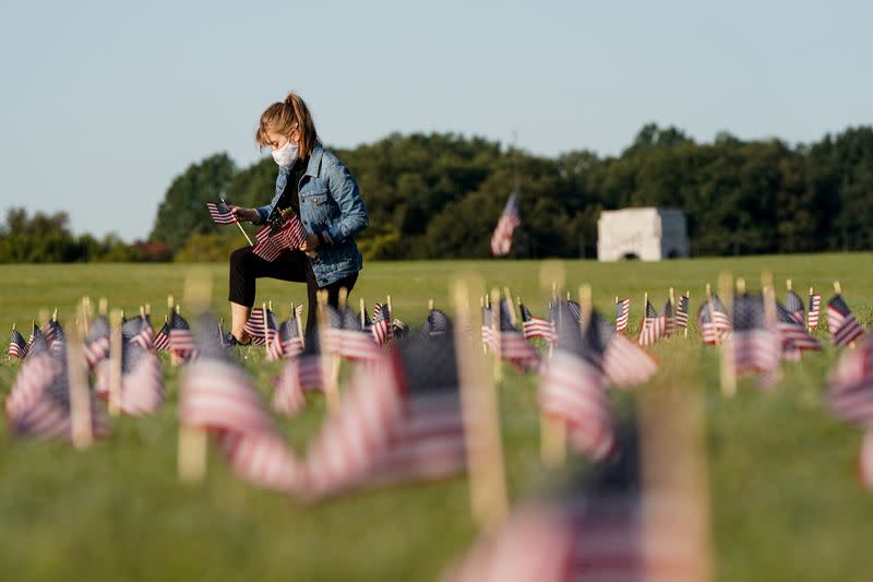 FILE PHOTO: American flags representing 200,000 lives lost due to coronavirus are placed on National Mall in Washington