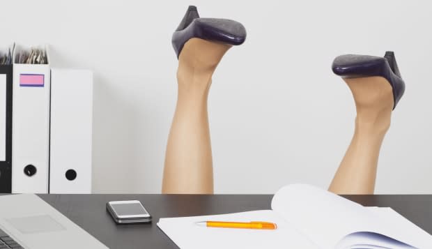 Business woman overturning behind office desk