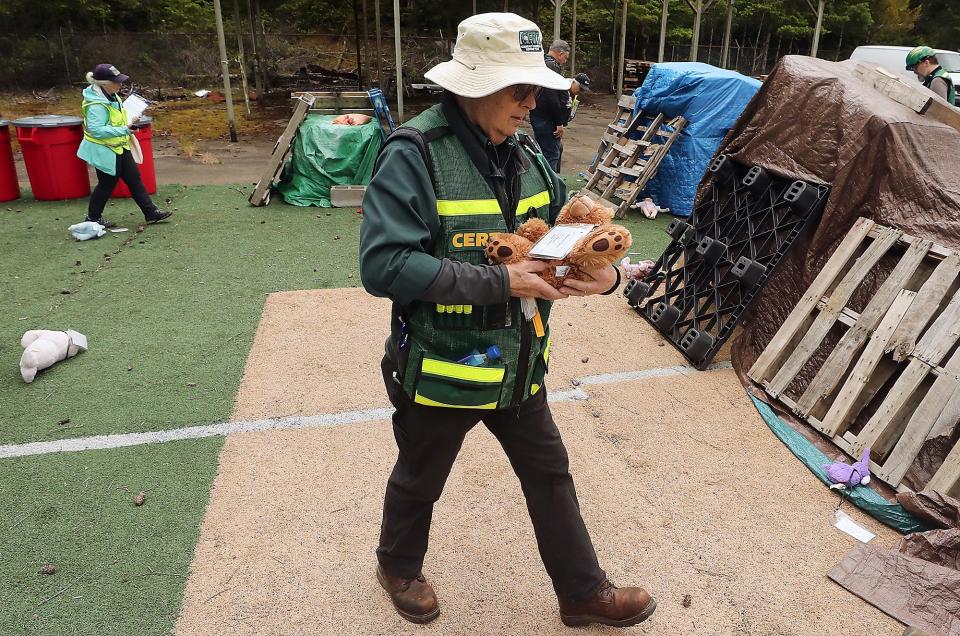 CERT's Michael Mijal carries a "victim" from a debris field to the medical tent during Kitsap Department of Emergency Management's drill on Friday.