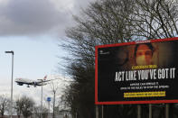 FILE- In this file photo dated Friday, Feb. 5, 2021, a plane comes in to land near a government coronavirus sign at Heathrow Airport in London. The return of international travel is key to economic recovery, particularly for countries that rely more heavily on tourism, according to figures released Thursday June 24, 2021, from the World Travel and Tourism Council. (AP Photo/Kirsty Wigglesworth, FILE)