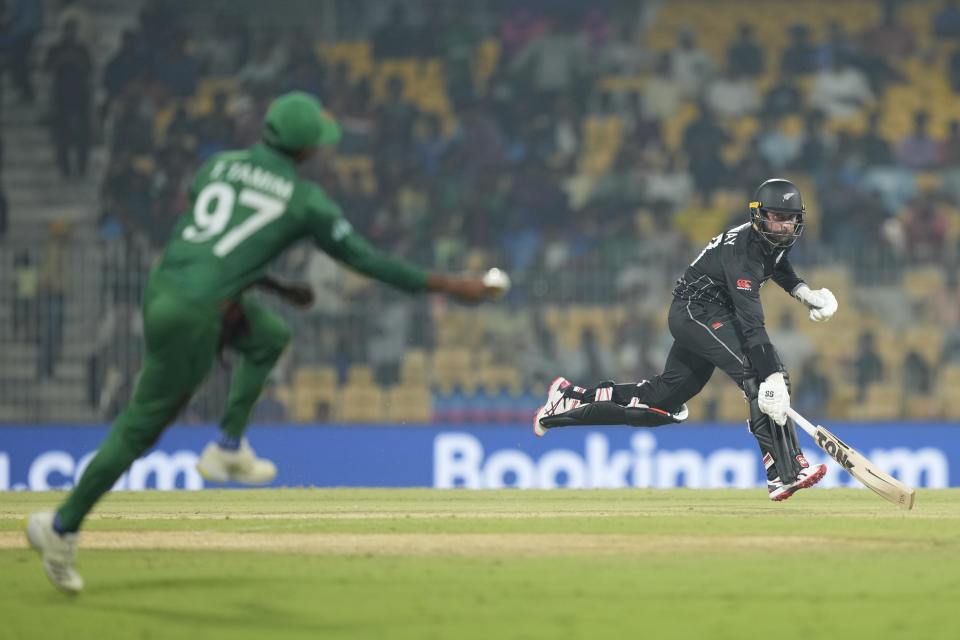 New Zealand's Devon Conway run between the wickets during the ICC Men's Cricket World Cup match between New Zealand and Bangladesh in Chennai , India, Friday, Oct. 13, 2023. (AP Photo/Eranga Jayawardena)